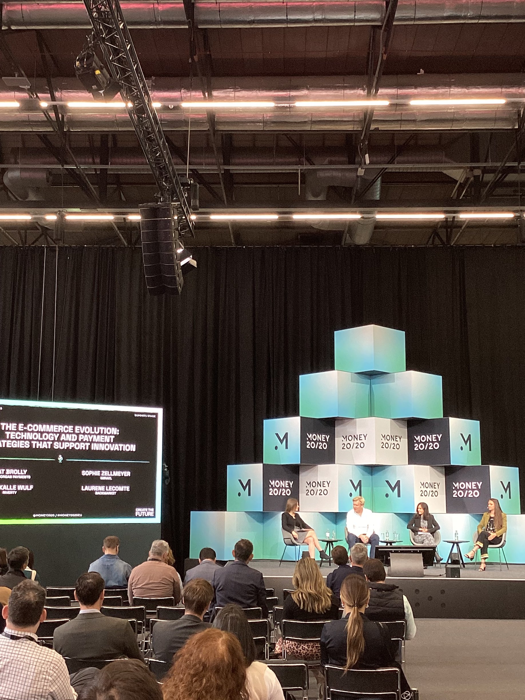 Panel session at Money 20/20 Europe 2025 with audience in view and branded stage backdrop.